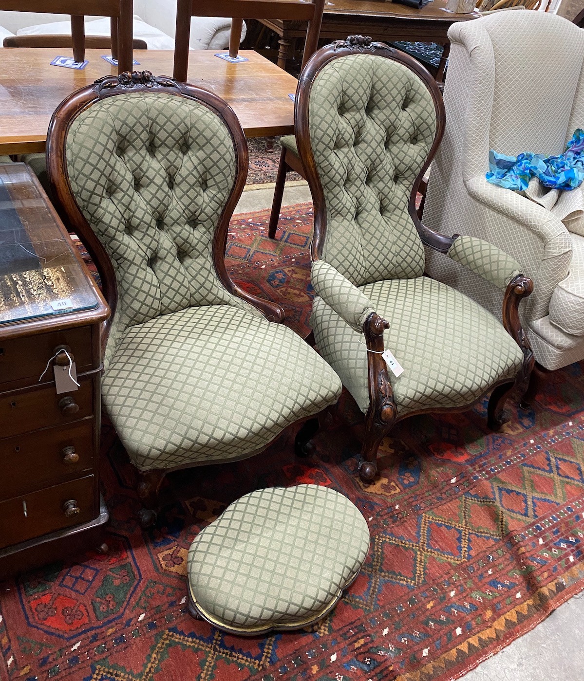 A pair of Victorian carved walnut spoon back chairs, one with arms together with a similar footstool